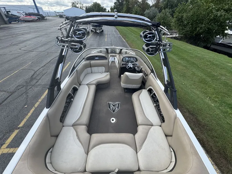 Slide: The Image of The image shows the interior of a 2007 Malibu Wakesetter 23 LSV with beige seating. - 5