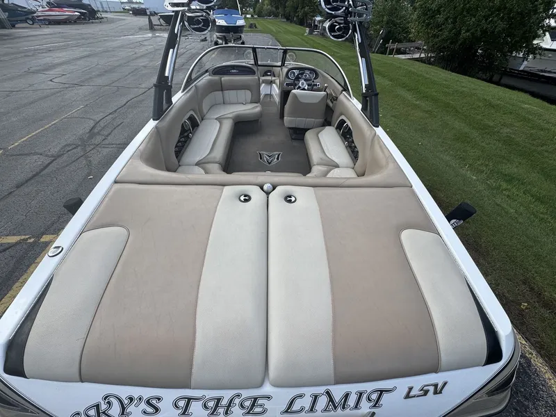 Slide: The Image of The image shows the interior of a 2007 Malibu Wakesetter 23 LSV with beige seating. - 4