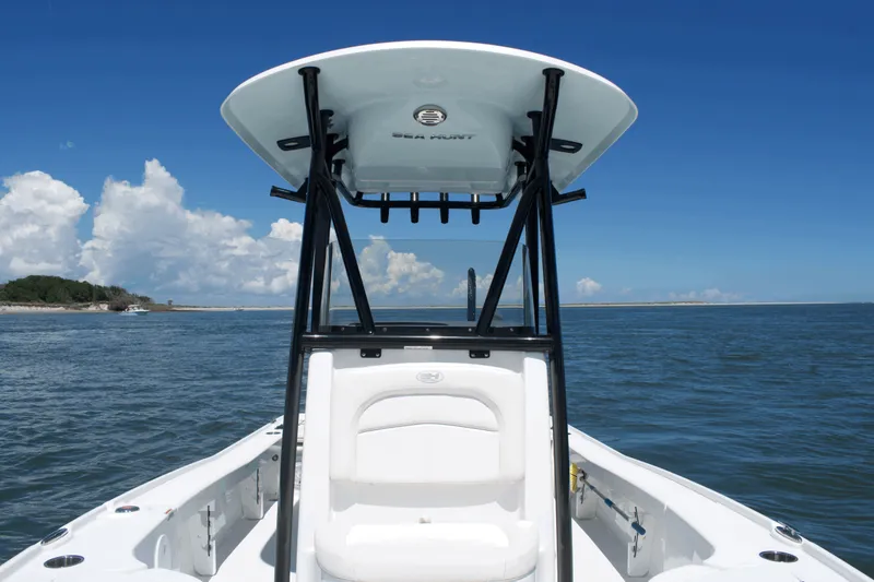 Slide: The Image of 2024 Sea Hunt BX22BR boat on open water under clear blue sky. - 10