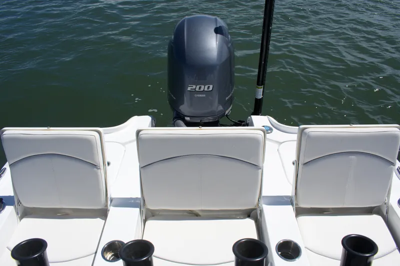 Slide: The Image of 2024 Sea Hunt BX22BR boat with Yamaha 200 engine, featuring three white seats. - 18
