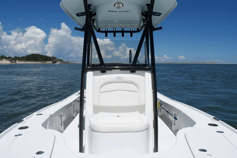 Slide: The Image of 2024 Sea Hunt BX22BR boat on open water under clear blue sky. - 9