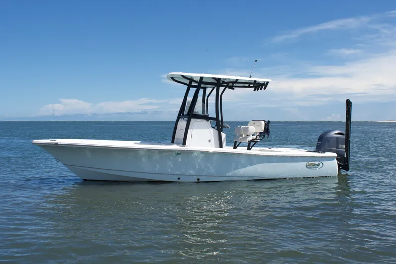 The Image of 2024 Sea Hunt BX22BR boat on calm water under clear blue sky. - 1