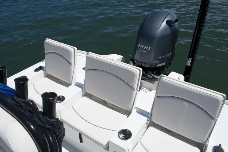 Slide: The Image of 2024 Sea Hunt BX22BR boat with Yamaha 200 engine and seating, on water. - 19