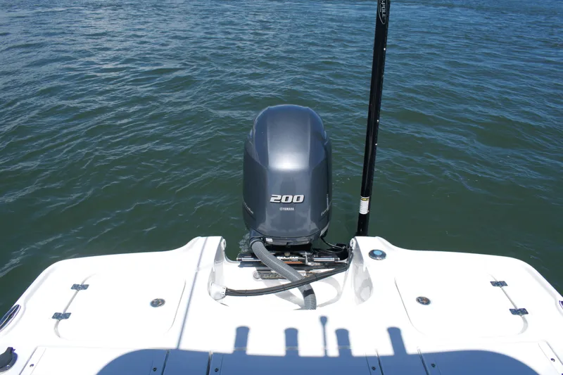 Slide: The Image of 2024 Sea Hunt BX22BR boat with Yamaha 200 engine on water. - 17