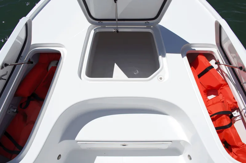 Slide: The Image of 2024 Sea Hunt BX22BR boat storage compartments with life jackets. - 8