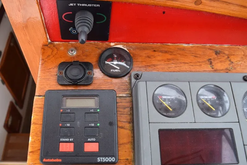Slide: The Image of 1974 Wasque 32 boat dashboard with fuel gauge, jet thruster, and Autopilot ST5000 controls. - 19