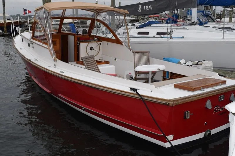 Slide: The Image of Classic 1974 Wasque 32 boat with red hull docked at marina. - 3