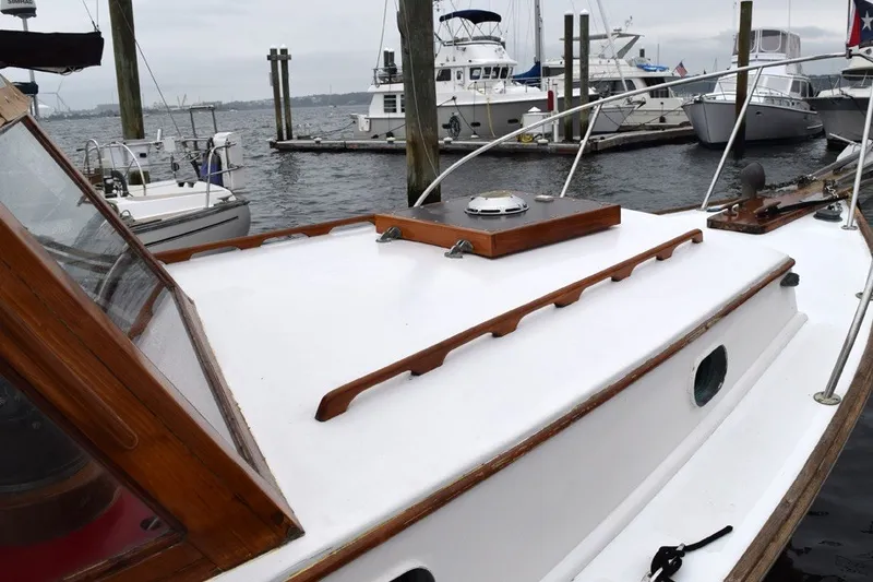 Slide: The Image of 1974 Wasque 32 boat docked at marina, featuring wooden accents and classic design. - 7