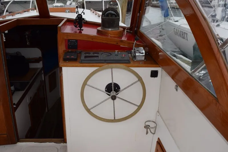 Slide: The Image of 1974 Wasque 32 boat helm with wooden accents and navigational instruments. - 16