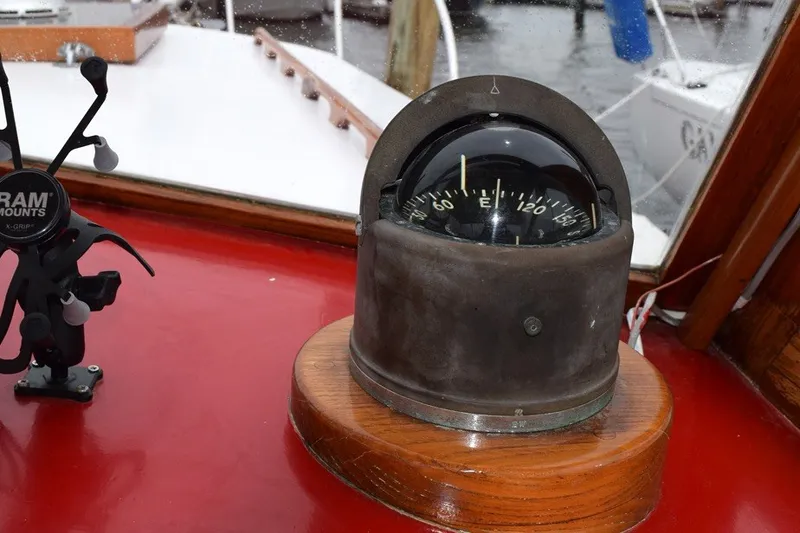 Slide: The Image of Vintage compass on 1974 Wasque 32 boat dashboard, with red surface and RAM mount. - 21