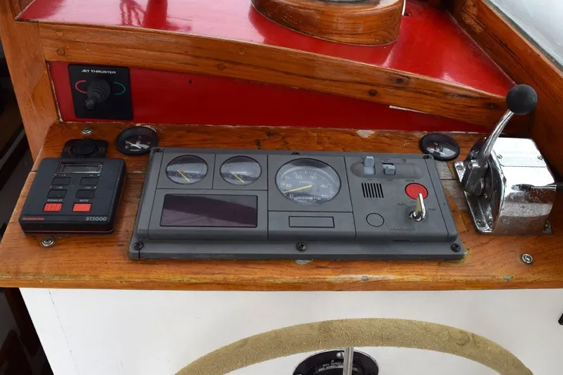 Slide: The Image of 1974 Wasque 32 boat dashboard with gauges, controls, and throttle lever. - 17