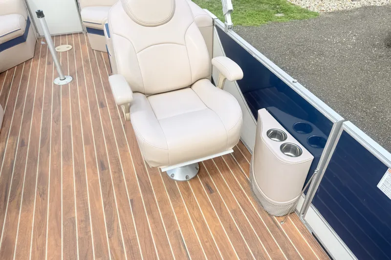 Slide: The Image of Luxurious beige captain's chair on 2017 South Bay 500 boat with wood-style flooring. - 10