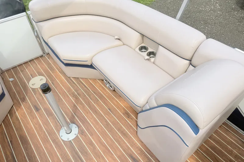 Slide: The Image of Luxurious seating on 2017 South Bay 500 boat with cup holders and wood-style flooring. - 4