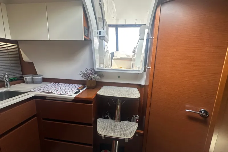 Slide: The Image of Interior of 2015 Jeanneau Leader 40 yacht with modern kitchen and wooden cabinetry. - 36