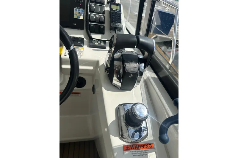Slide: The Image of Control panel of a 2015 Jeanneau Leader 40 boat, featuring steering and throttle controls. - 27