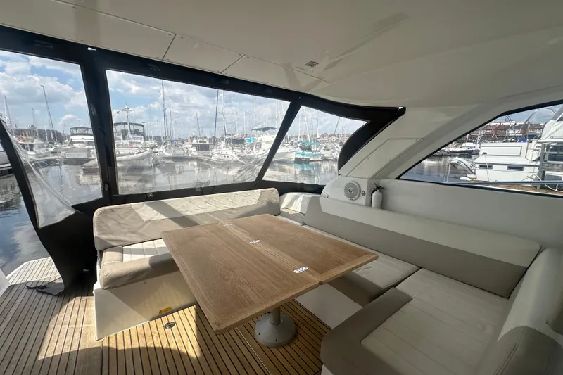 Slide: The Image of Interior view of 2015 Jeanneau Leader 40 yacht with seating and table in marina. - 20