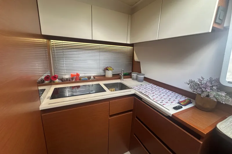 Slide: The Image of Compact kitchen area in a 2015 Jeanneau Leader 40 yacht with modern amenities. - 35