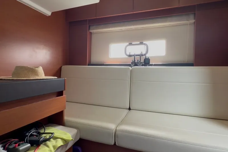 Slide: The Image of Interior of 2015 Jeanneau Leader 40 yacht with white seating and wooden accents. - 37