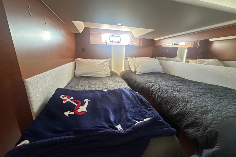 Slide: The Image of Cozy cabin interior of 2015 Jeanneau Leader 40 yacht with twin beds and nautical decor. - 38