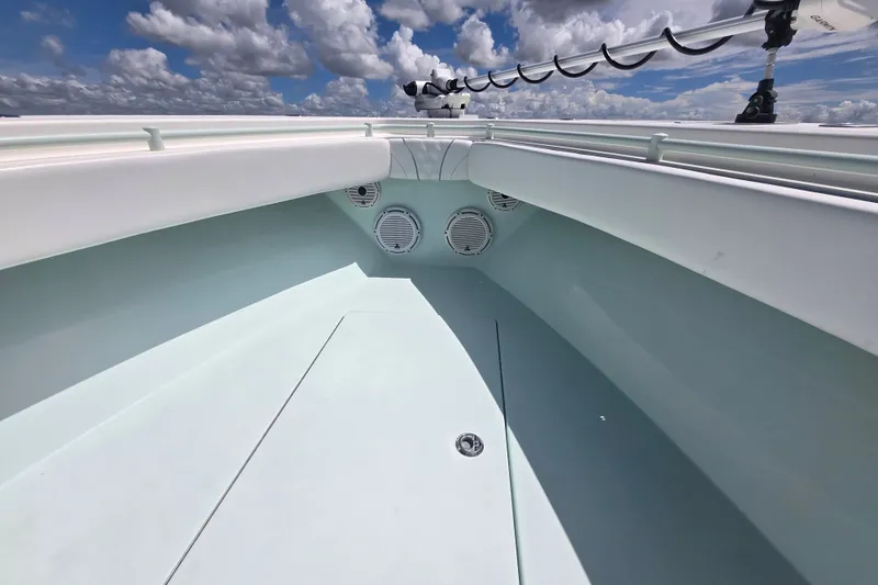 Slide: The Image of 2019 Contender 30 ST boat interior with speakers, under a cloudy sky. - 37