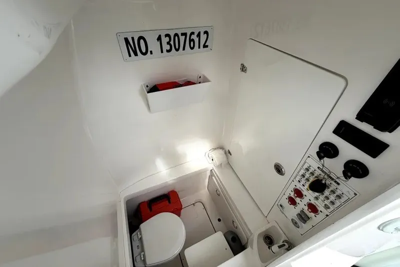 Slide: The Image of Interior of a 2019 Contender 30 ST boat with control panel and storage. - 23