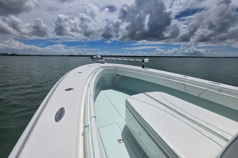 Slide: The Image of 2019 Contender 30 ST boat on calm water under a partly cloudy sky. - 34