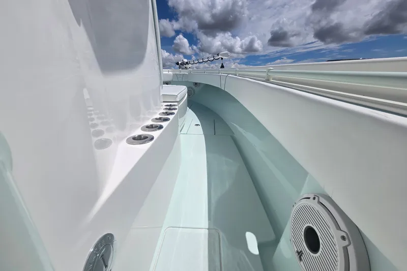Slide: The Image of 2019 Contender 30 ST boat interior with rod holders, under a partly cloudy sky. - 59