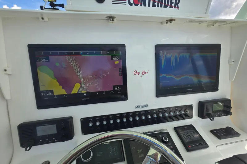 Slide: The Image of Dashboard of a 2019 Contender 30 ST boat with navigation and sonar displays. - 47