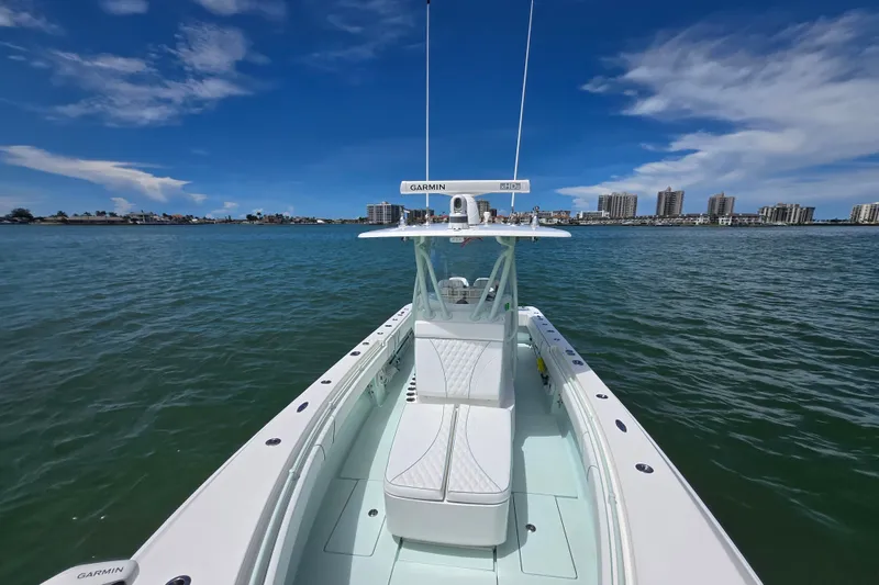 Slide: The Image of 2019 Contender 30 ST boat on water with city skyline in background. - 25