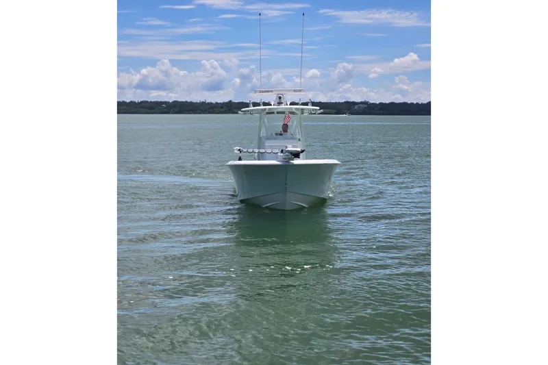 Slide: The Image of 2019 Contender 30 ST boat on calm water under a blue sky. - 7