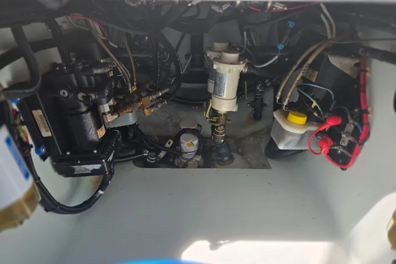 Slide: The Image of Engine compartment of a 2019 Contender 30 ST boat, showcasing mechanical components and wiring. - 79