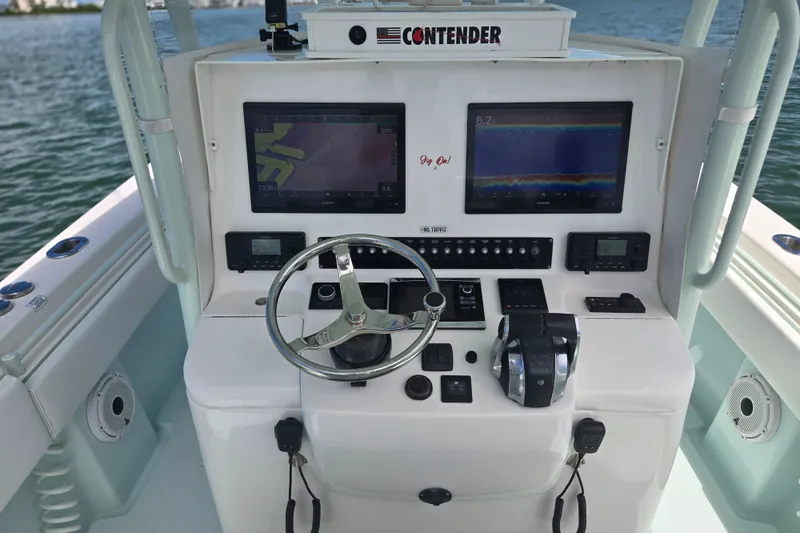 Slide: The Image of 2019 Contender 30 ST boat dashboard with navigation screens and controls. - 42