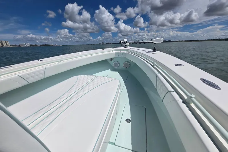 Slide: The Image of 2019 Contender 30 ST boat on calm water under a partly cloudy sky. - 39