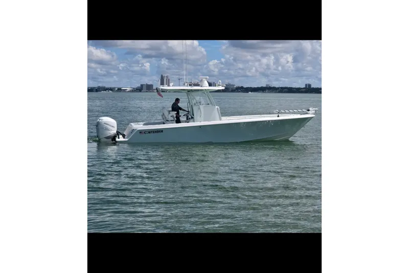 Slide: The Image of 2019 Contender 30 ST boat cruising on calm waters under a cloudy sky. - 1