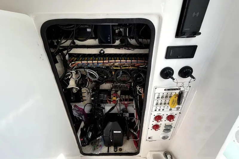 Slide: The Image of Electrical panel of a 2019 Contender 30 ST boat, showcasing wiring and controls. - 24