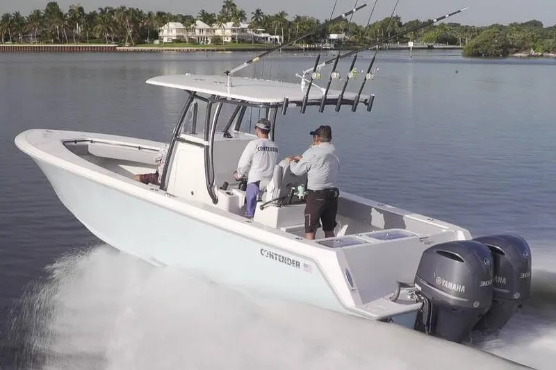 Slide: The Image of Manufacturer Provided Image: 2019 Contender 30 ST boat cruising on a calm lake with fishing rods. - 3