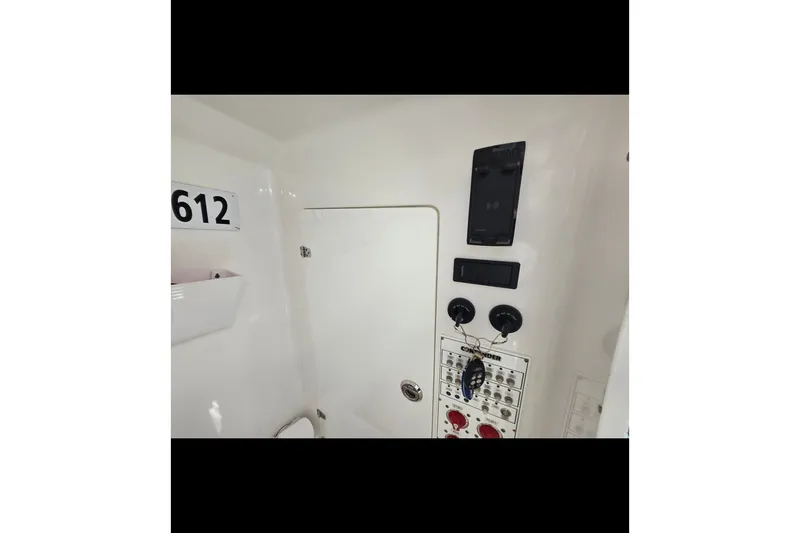 Slide: The Image of Control panel inside 2019 Contender 30 ST boat, featuring switches and key holder. - 71