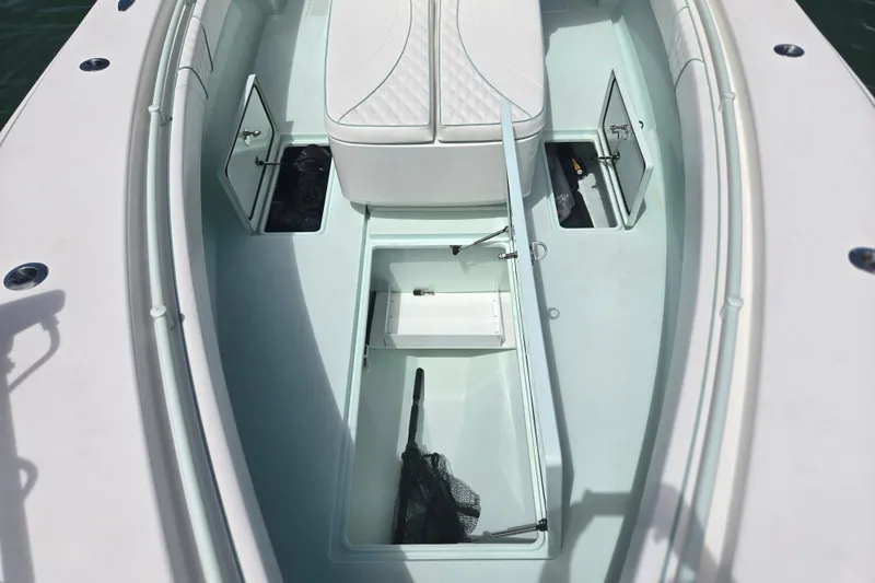 Slide: The Image of 2019 Contender 30 ST boat interior with open storage compartments and seating. - 29