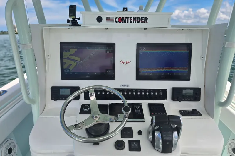Slide: The Image of Dashboard of a 2019 Contender 30 ST boat with navigation screens and controls. - 43