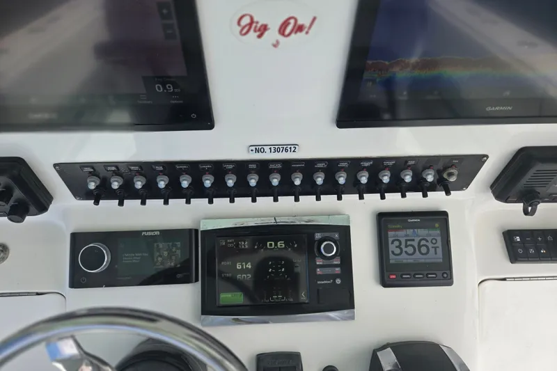 Slide: The Image of Dashboard of a 2019 Contender 30 ST boat with navigation and control systems. - 44