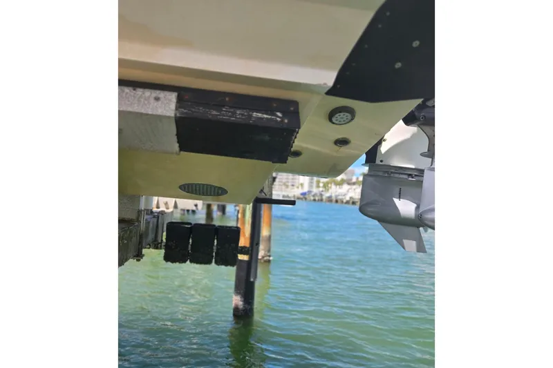 Slide: The Image of 2019 Contender 30 ST boat hull and motor detail over water. - 24