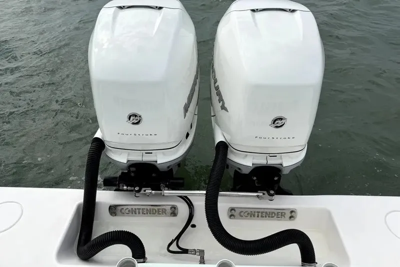 Slide: The Image of Twin Mercury FourStroke engines on a 2019 Contender 30 ST boat in water. - 20