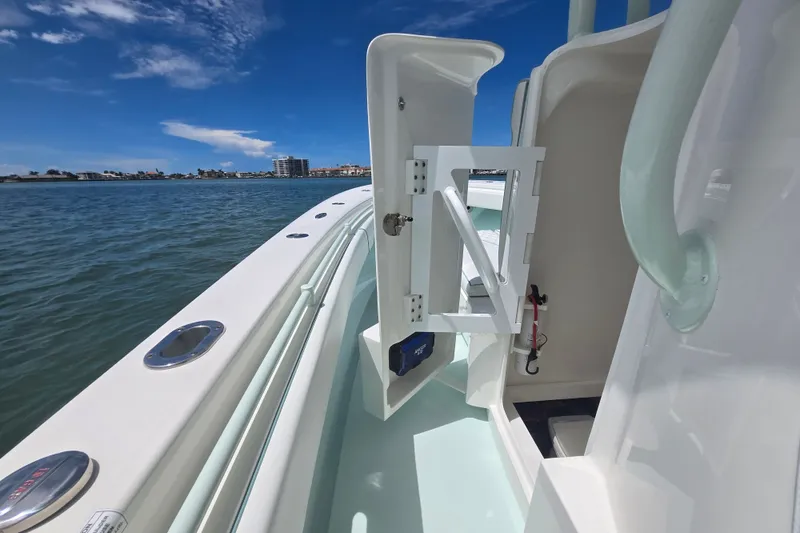Slide: The Image of 2019 Contender 30 ST boat interior with open hatch, ocean view, and clear blue sky. - 66