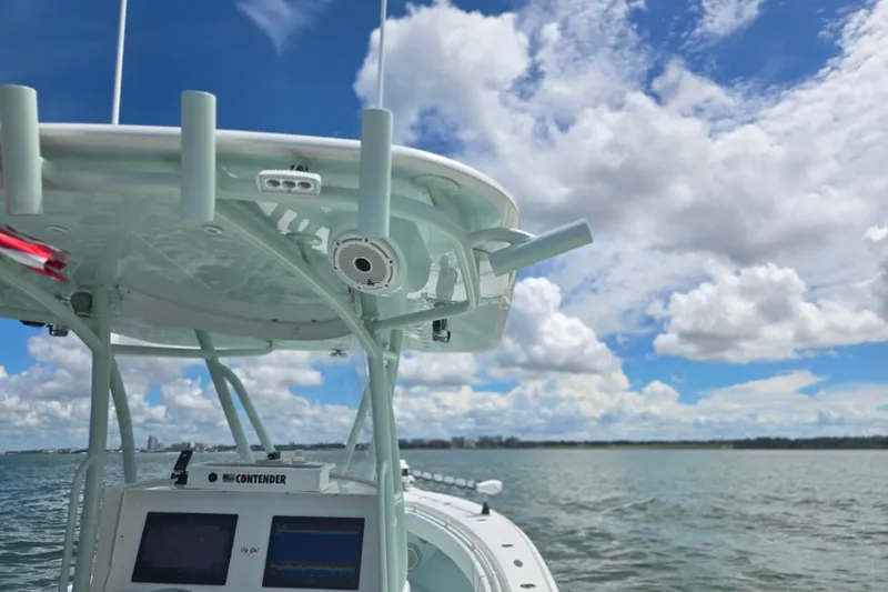 Slide: The Image of 2019 Contender 30 ST boat on water under blue sky with clouds. - 56