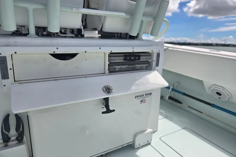 Slide: The Image of 2019 Contender 30 ST boat interior with storage compartments and fishing rod holders. - 53