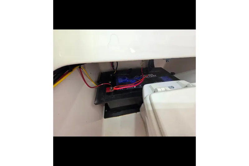 Slide: The Image of Battery compartment of a 2019 Contender 30 ST boat with wiring connections. - 70