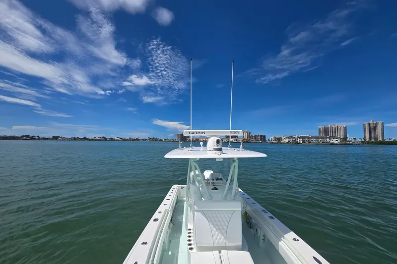 Slide: The Image of Contender 30 ST 2019 boat on calm water with city skyline and blue sky. - 28