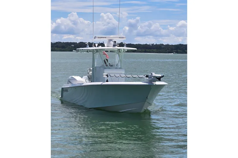 Slide: The Image of 2019 Contender 30 ST boat on calm water under a partly cloudy sky. - 6