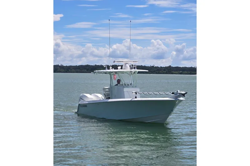 Slide: The Image of 2019 Contender 30 ST boat cruising on calm waters under a blue sky. - 5
