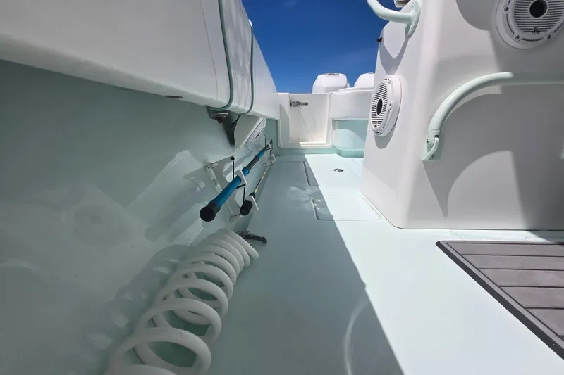 Slide: The Image of 2019 Contender 30 ST boat interior with fishing rod holders and marine speakers. - 51
